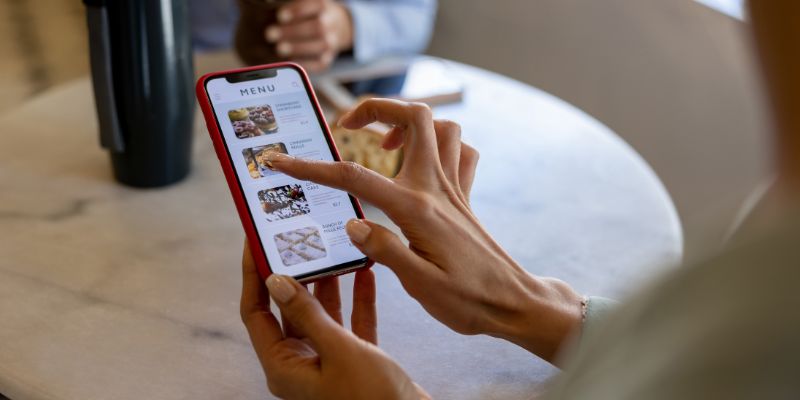 A Filipino customer viewing the menu through her smartphone