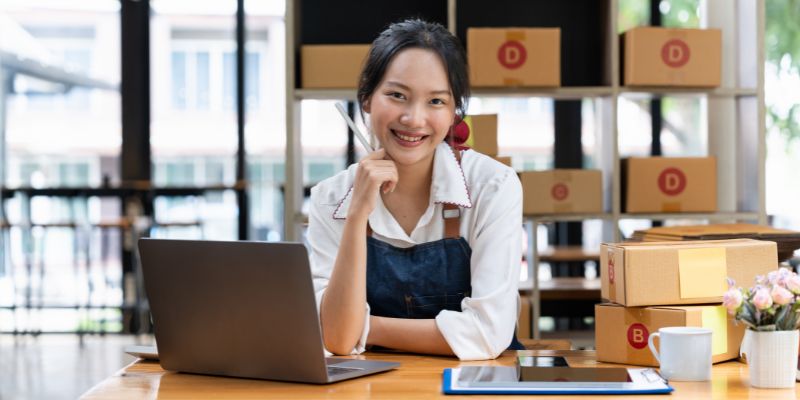 Filipino business owner keeping track of her stock