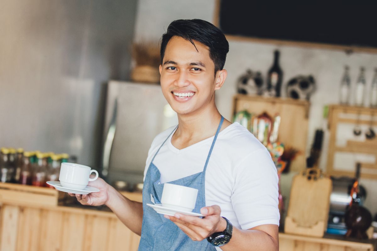 A Filipino restaurant owner smiling