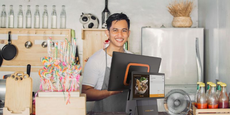 A Filipino small business owner with a StoreHub point-of-sale (POS) system