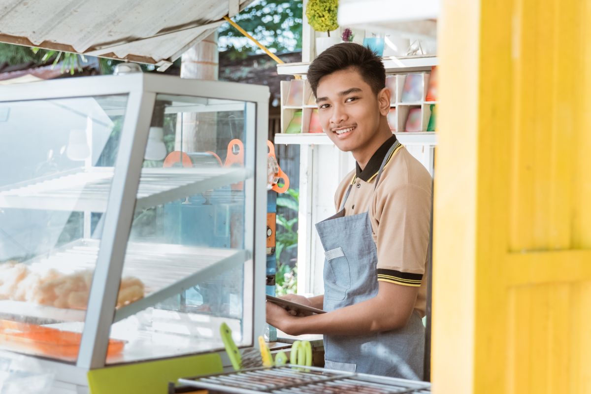 A Filipino business owner inside his food stall