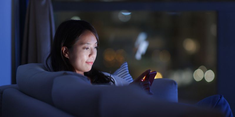 A Filipino business owner using her phone to check on her business at home