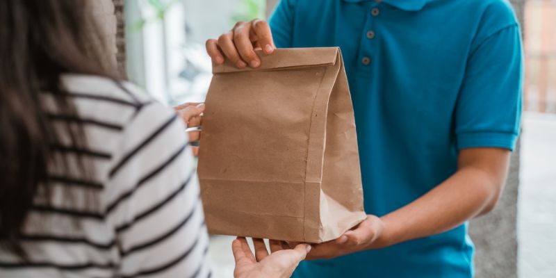 A Filipino customer receiving her food delivery