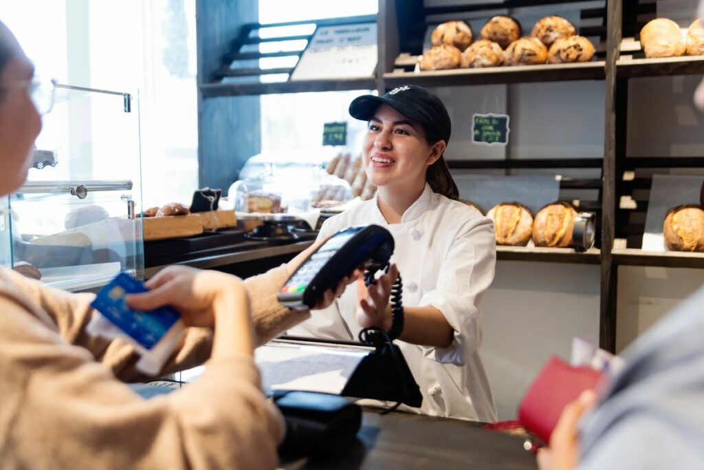 A Filipino restaurant owner serving a customer