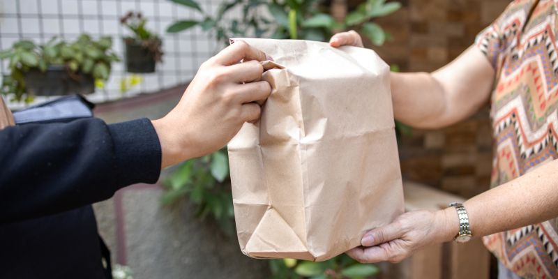 A customer receiving her food delivery