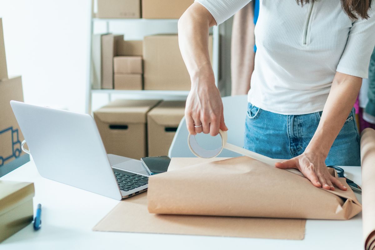 A female retail business owner packing an order
