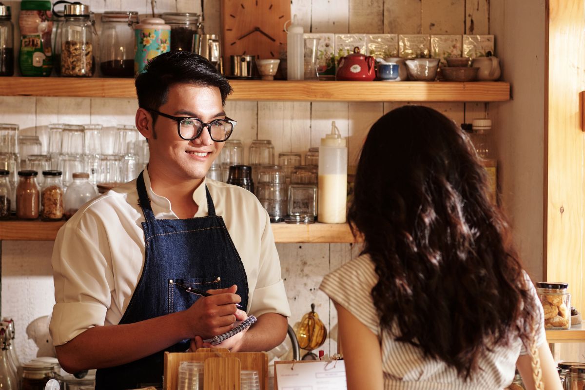 A Filipino F&B staff talking with a customer