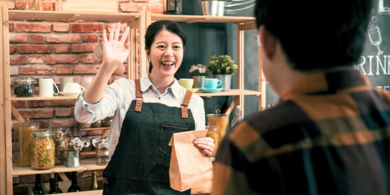 A Filipino F&B staff serving a customer