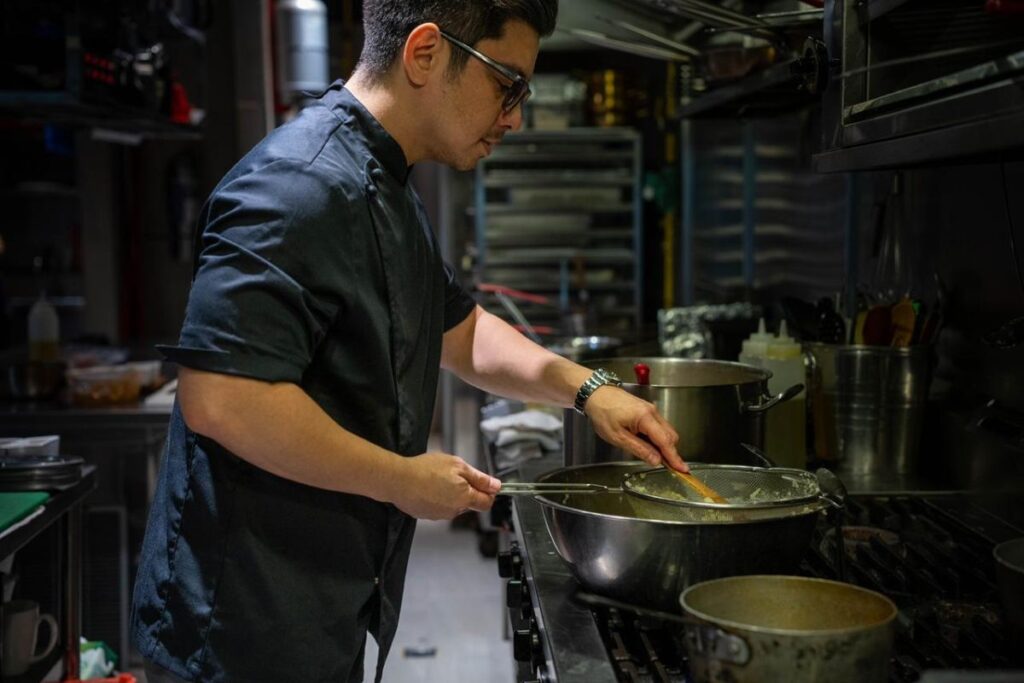Jan Rodriguez of The Weekend cooking in the kitchen
