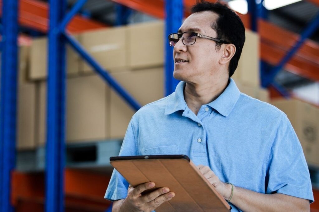 Filipino business owner checking inventory at warehouse
