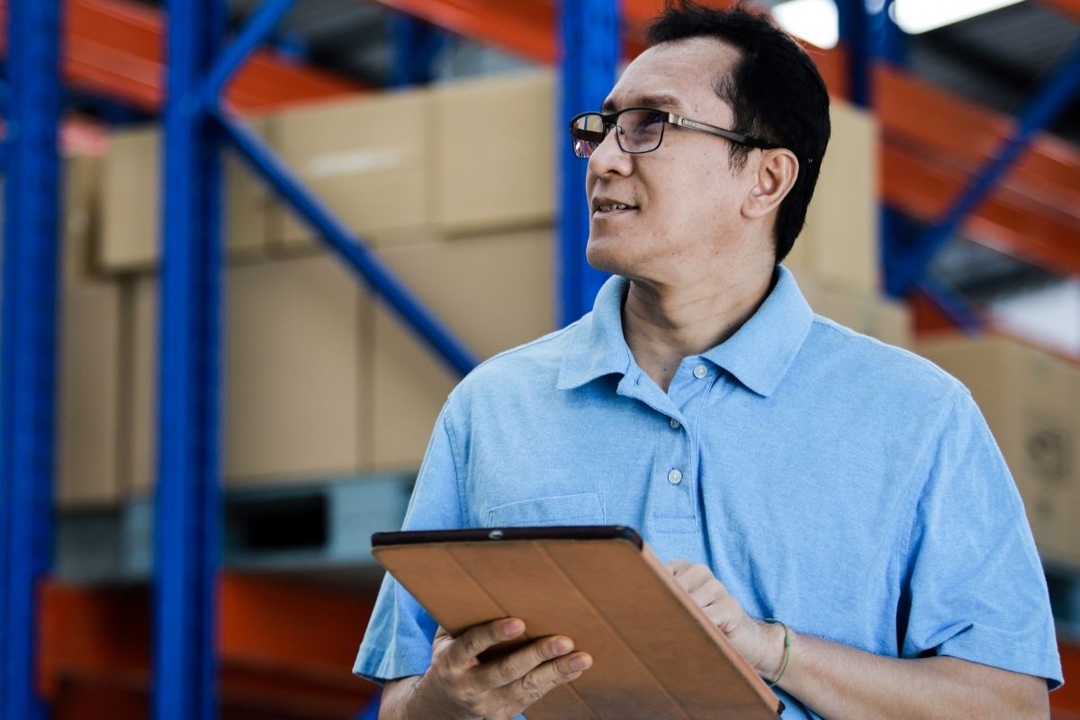 Filipino business owner checking inventory at warehouse