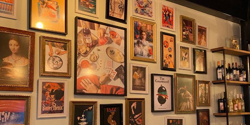 A wall of paintings at a Filipino restaurant