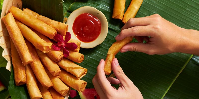 A woman making lumpia