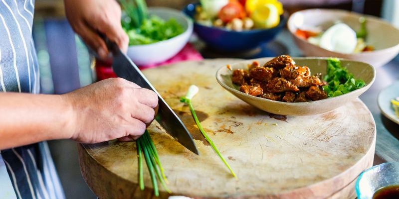 A Filipino woman cooking Filipino food