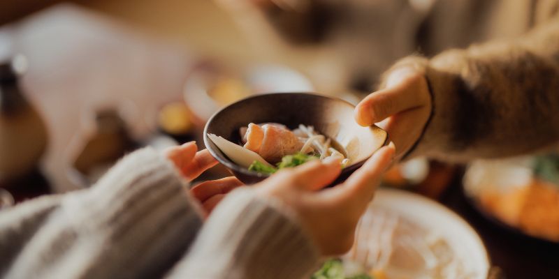 Customers sharing a bowl of food
