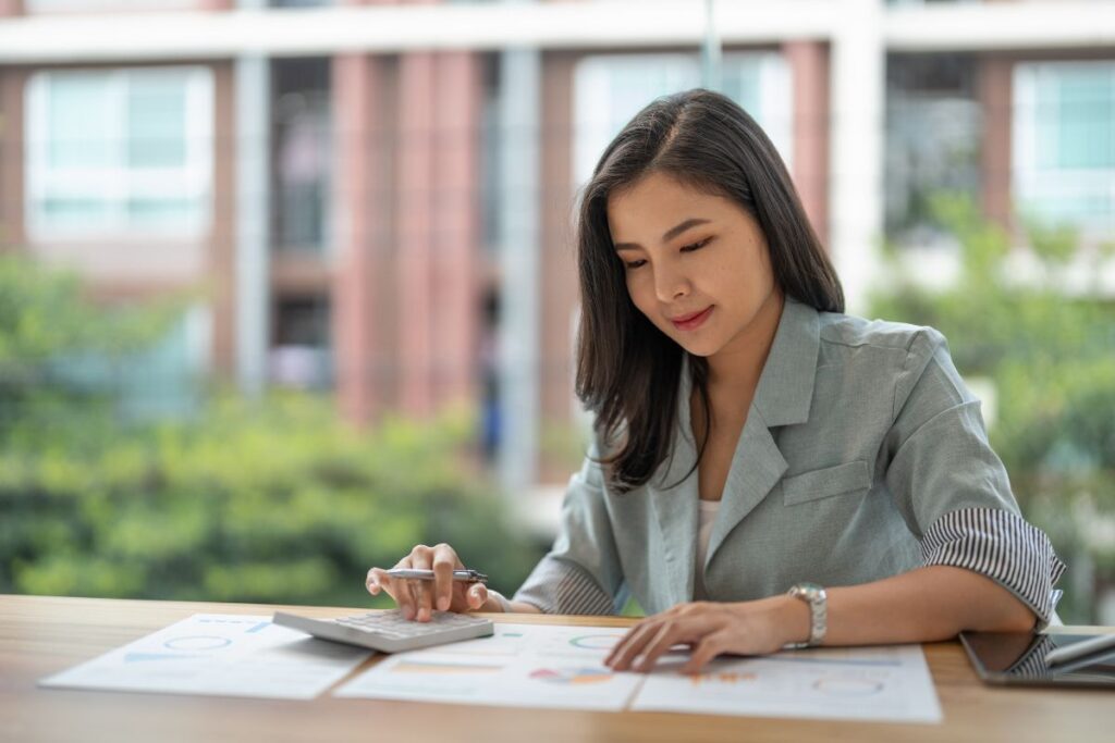 A Filipino business owner working on her business' budget
