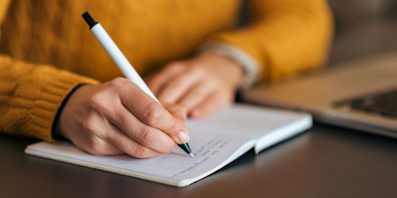 A Filipino business owner writing in a notebook