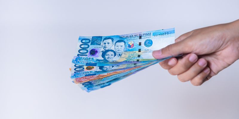 A Filipino business owner counting money