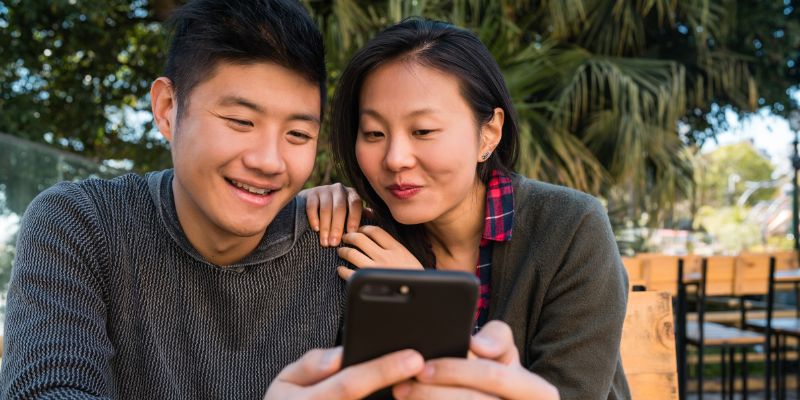 A Filipino couple looking at a phone