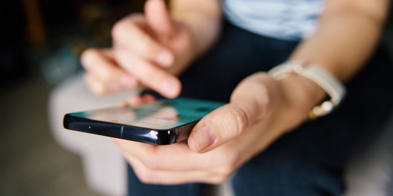 A Filipino woman scrolling through her phone
