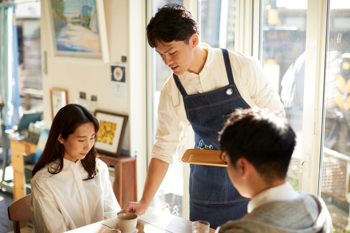 A Filipino F&B staff serving customers