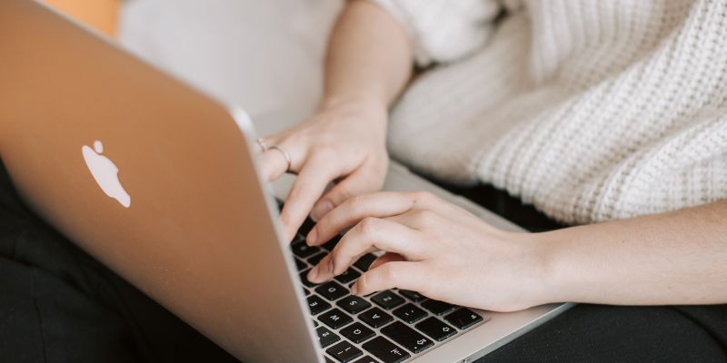 A Filipino woman typing on her laptop