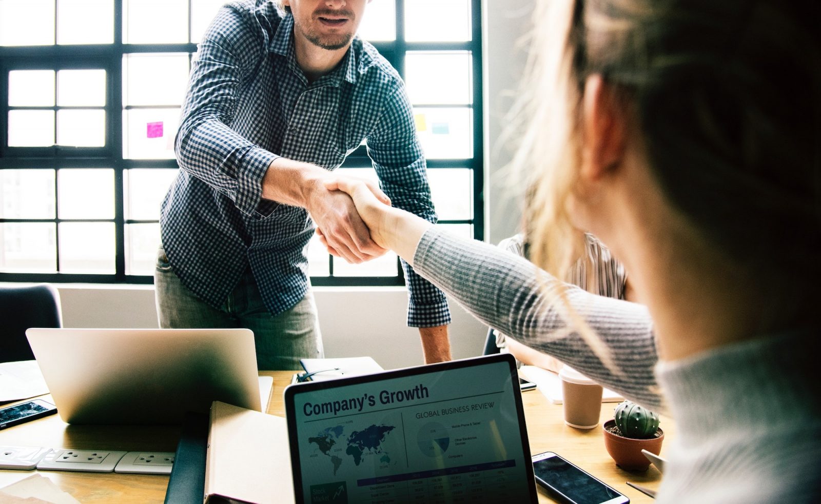 man woman shaking hands