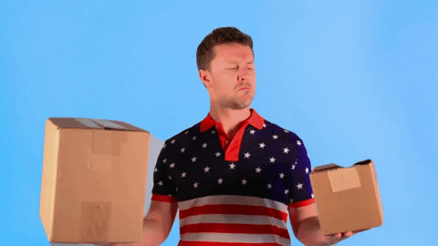 man weighing boxes in hands