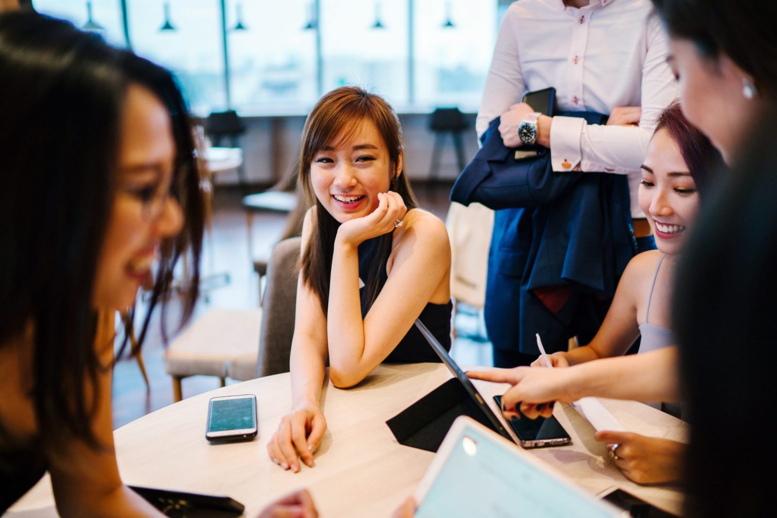 group of people sitting meeting laughing