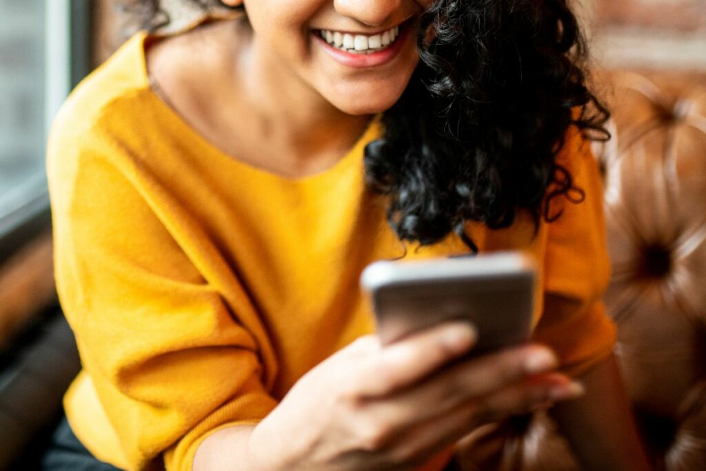 A woman on her phone at a cafe