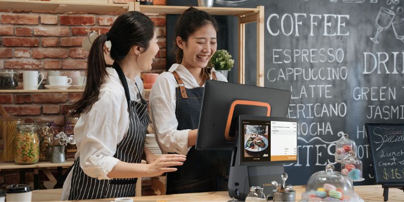 Two Malaysian business owners with a StoreHub POS in their cafe