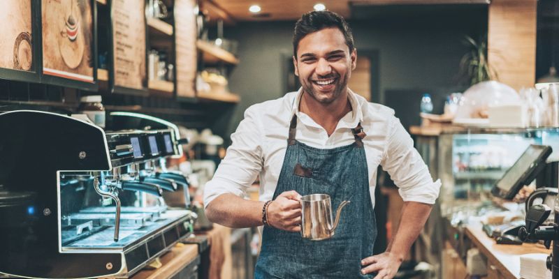A male barista in a cafe