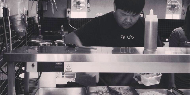 Ahong scooping up food from serving trays during his days operating a food stall at PPUM.