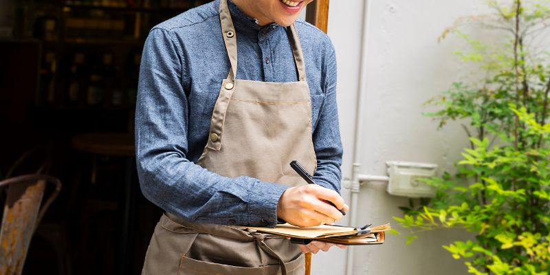 A waiter taking down orders