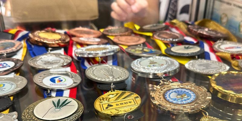 Badminton championship medals displayed at a retail store