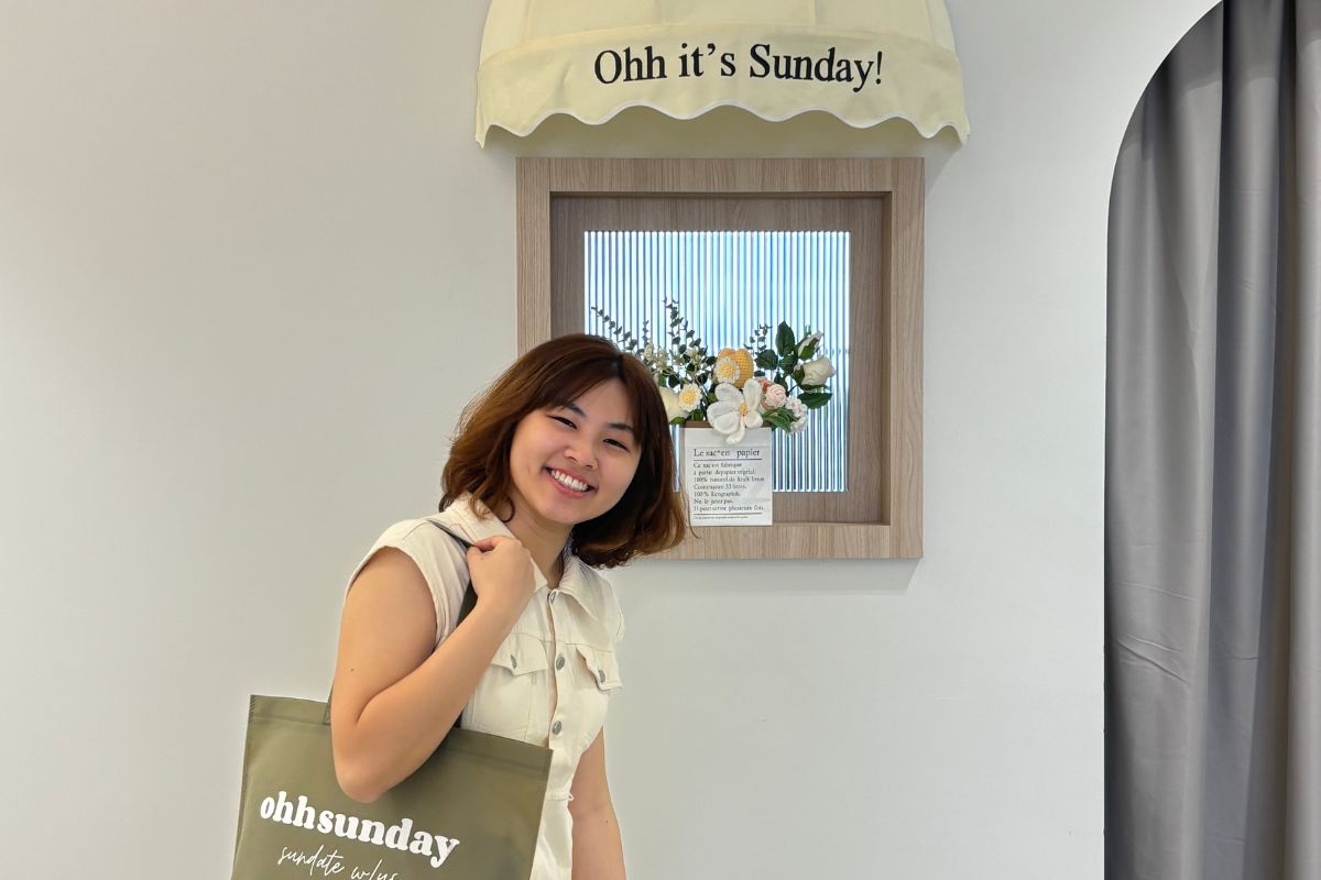 Owner of Ohh Sunday. posing within the store