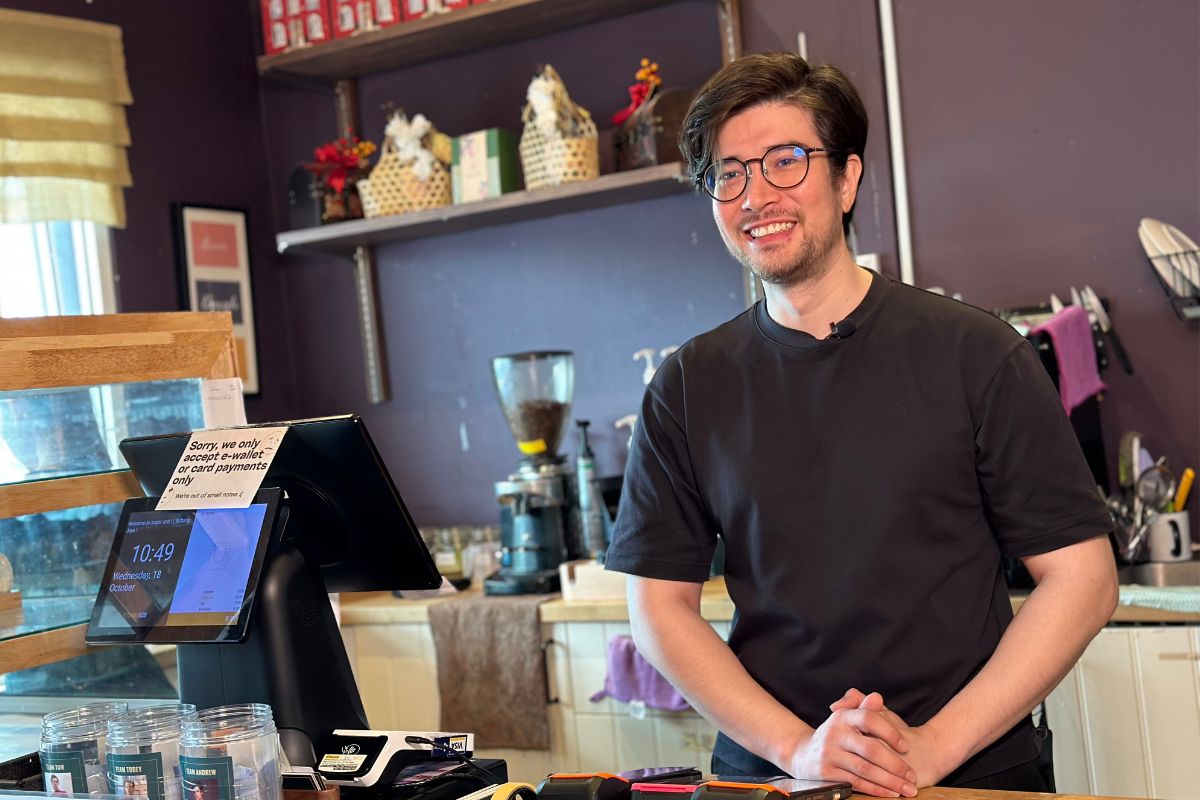 Ilyas, co-owner of Sugar And I, standing behind the counter