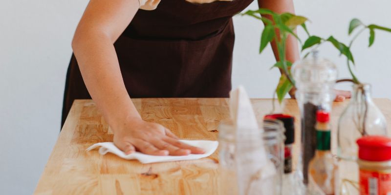 A Malaysian F&B staff wiping down the table